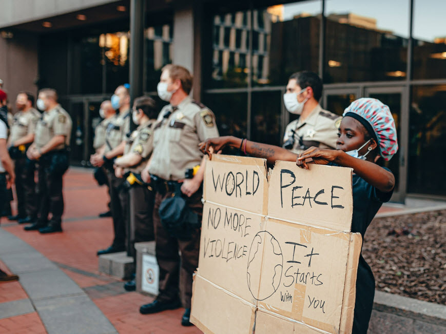 Protestor holding sign saying 