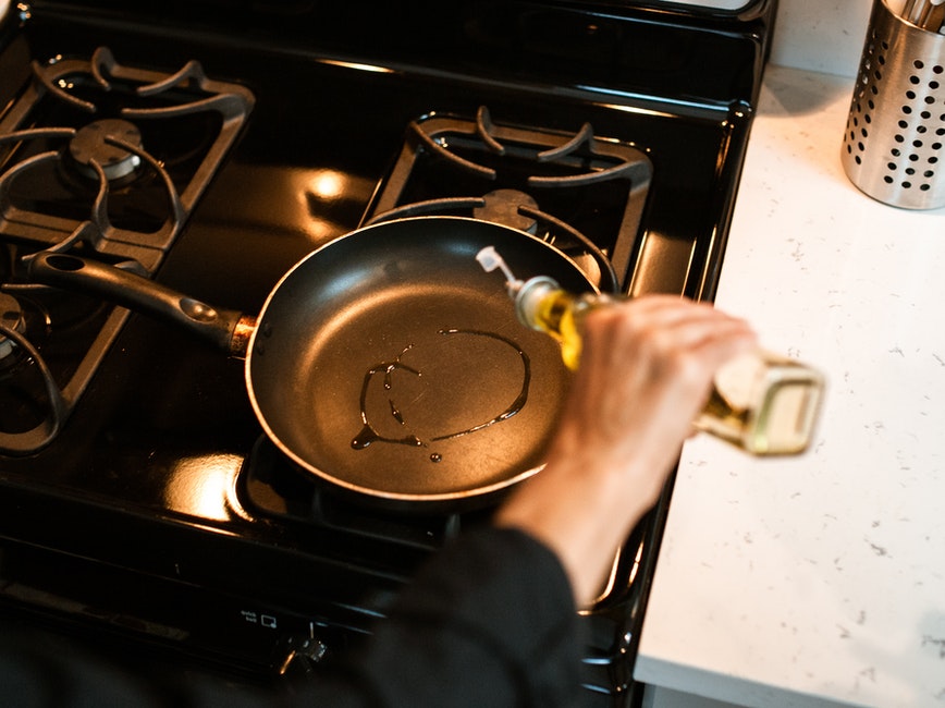 Pouring oil into a pan