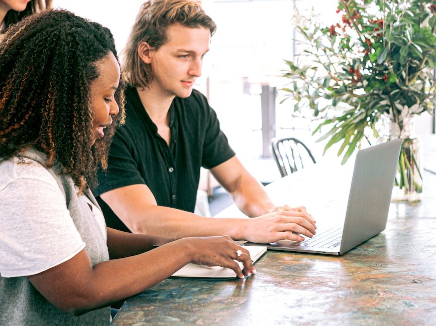 Two coworkers working together at laptop