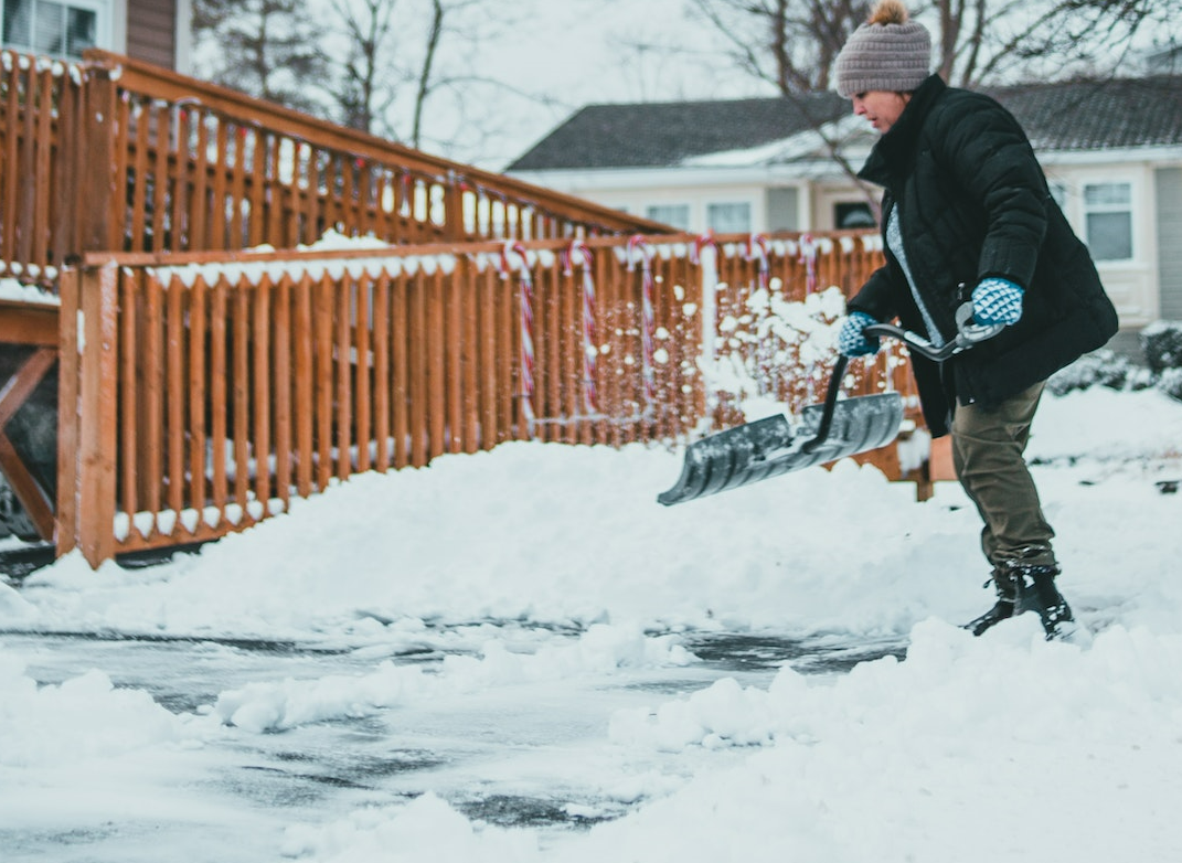 Person shoveling sidewalk in snow