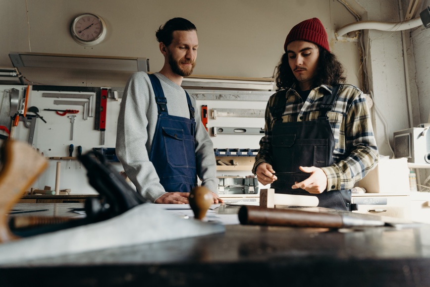 Two people in workspace with tools